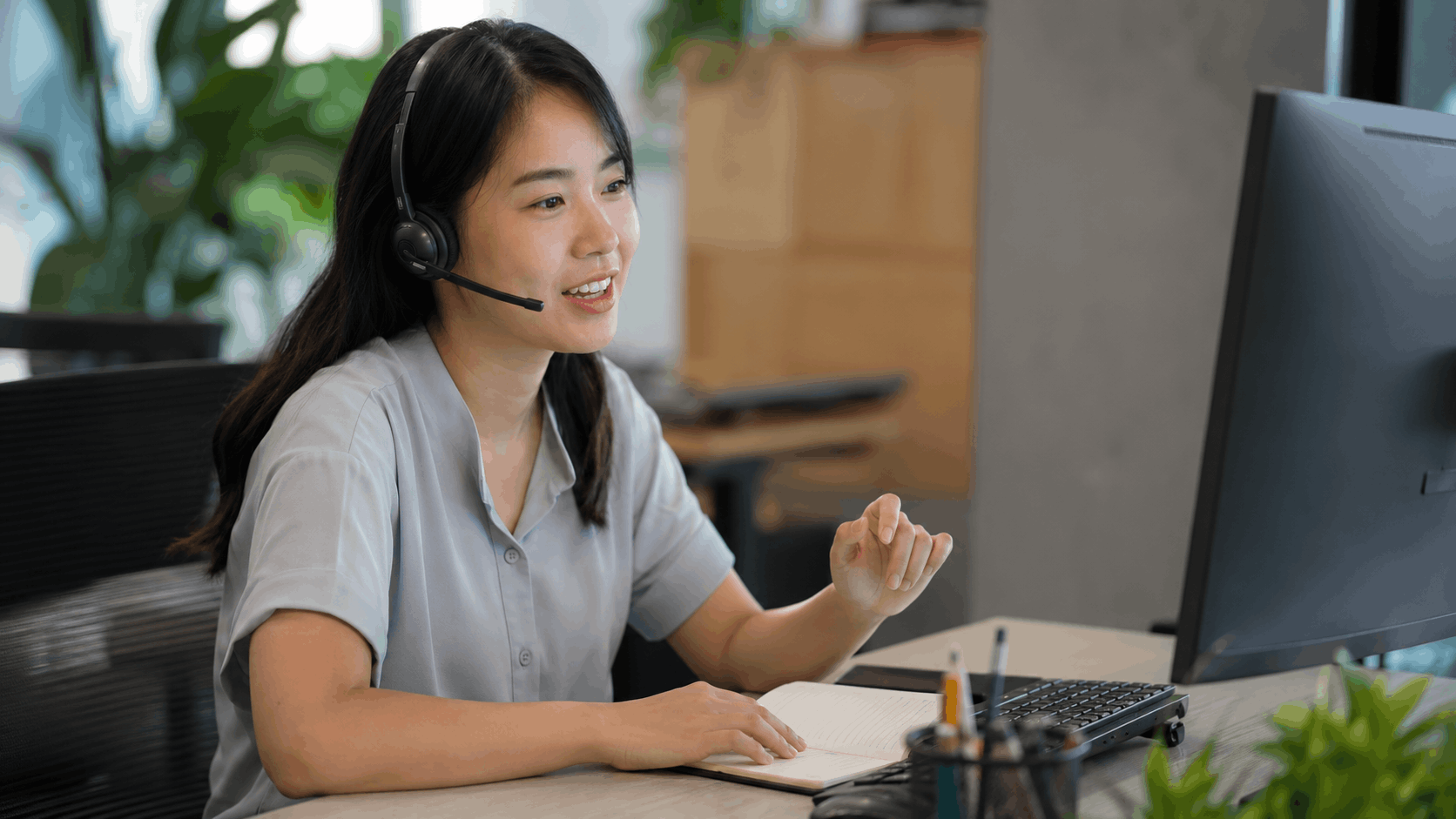 A customer service representative wearing a headset and helping a customer